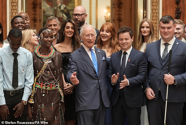 Declan Donnelly standing to the immediate right of King Charles noted he had offered to write the TV presenter 'some jokes', adding 'he's got a fantastic sense of humour'. The monarch can be seen here posing for photos with The King's Trust ambassadors and this year's award winners