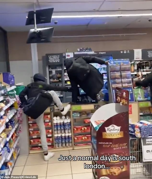 A video grab of the moment three brazen thieves jump over Asda petrol station store counter to steal booze and fags