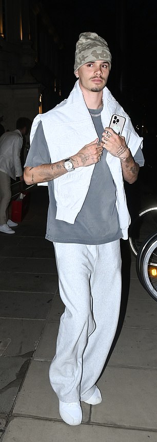The aspiring tennis player was casually clad in grey jogging bottoms paired with a T-shirt and a hoodie draped over his shoulders