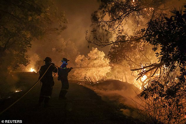 GREECE: Firefighters try to tackle a wildfire burning on Chios island, June 23