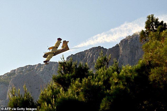 CROATIA: Severe forest fires destroyed around 700 hectares of land on the Croatian coast this week. Picture shows water bombing aircraft dropping water during a wildfire near the coastal town of Omis on June 21