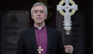 Andrew John poses with the Cross of Wales ahead of the blessing of the cross at Holy Trinity Church, Llandudno on April 19, 2023