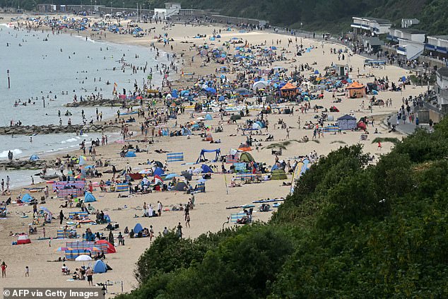 ENGLAND -- Sunbathers cover the beaches in Bournemouth on the south coast