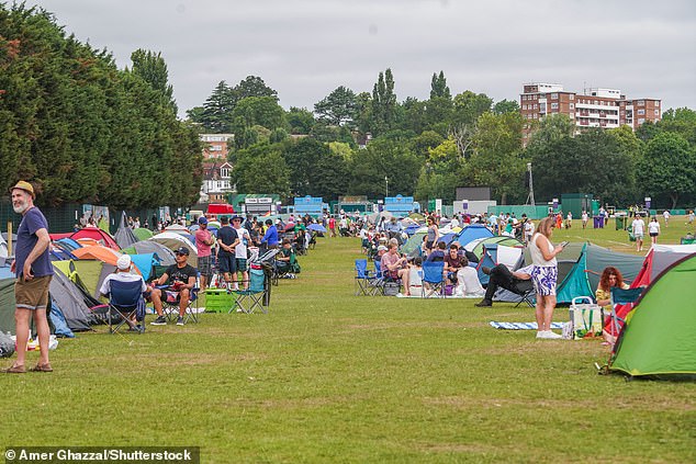 WIMBLEDON -- People bring their camping gear as they queue in the baking heat for tomorrow's opening day