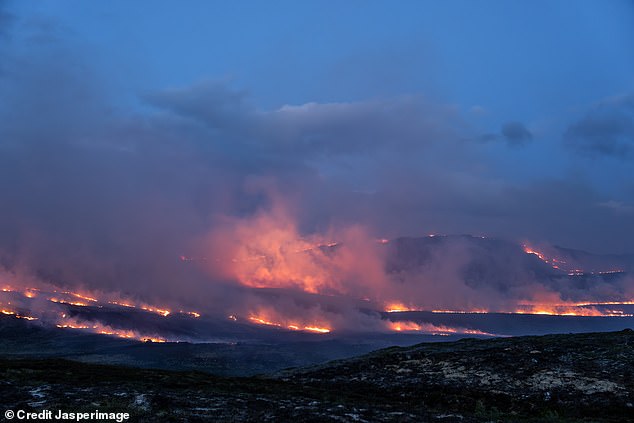 A wildfire breaks out over hills between Carrbridge and Grantown-on-Spey in Scotland