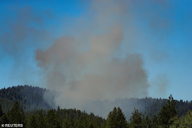 The fire was still blazing Sunday night as crews were forced to pull back when the shooting began