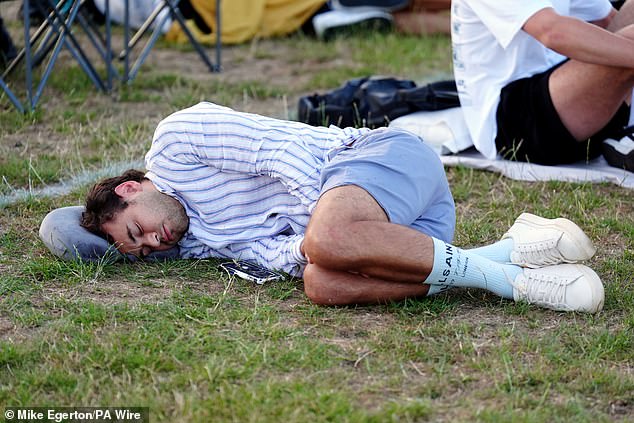A man sleeps in Wimbledon park to try and get tickets into the grounds today