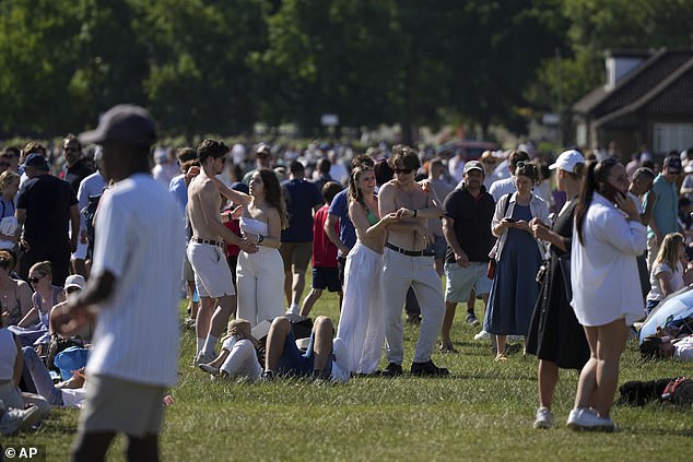 People queue at the entrance on the first day of the Wimbledon