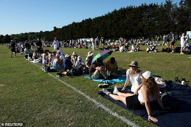 People sunbath as temperatures rise in Wimbledon Park