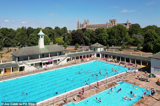 People enjoy the hot weather as they swim at Peterborough Lido in Peterborough, Cambridgeshire