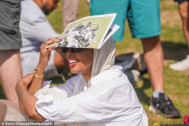 Thousands of ticketless tennis fans queuing in Wimbledon Park in the hot sunshine