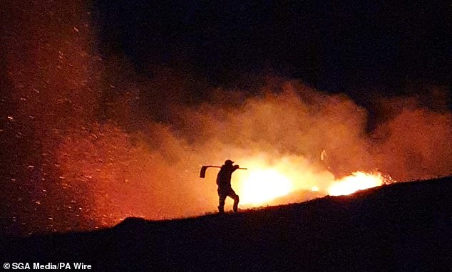 A gamekeeper tacking a wildfire. Gamekeepers who have helped battling wildfires have warned such blazes are "becoming a danger to human life"