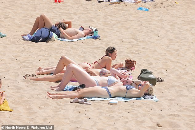 Sunbathers enjoy the warm weather at king Edwards Bay in Tynemouth today