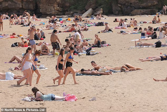 People cooling off in the North Sea at king Edwards Bay in Tynemouth