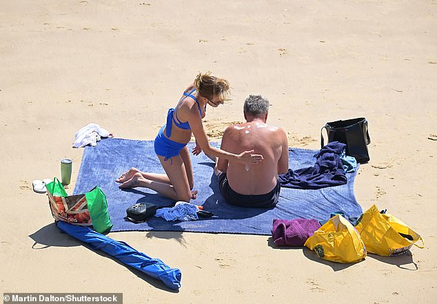 Beach-goers make sure they wear sunscreen to protect from the scorching temperatures