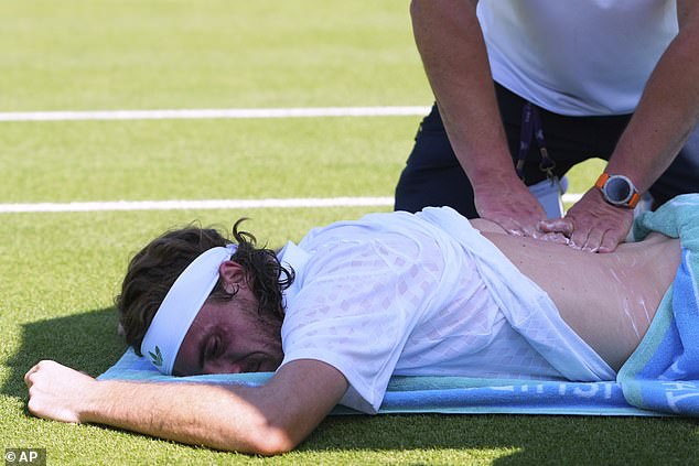 Stefanos Tsitsipas of Greece receives treatment during his first round men's single match against Valentine Royer of France