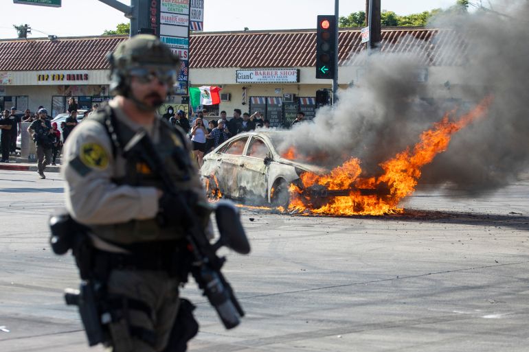 A car burns during a protest following federal immigration operations, in the Compton neighbourhood of Los Angeles, California on June 7, 2025. [File: Ringo Chiu/AFP]