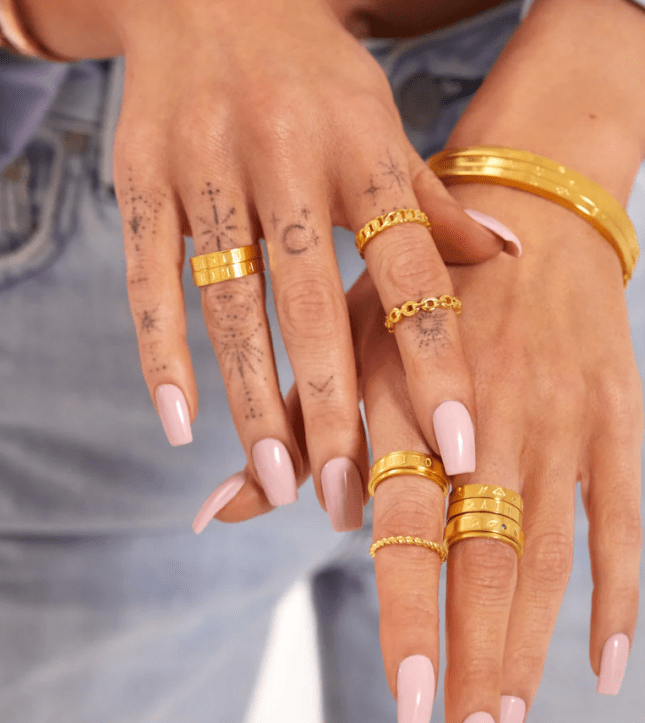 Female hands show gold rings placed on fingers