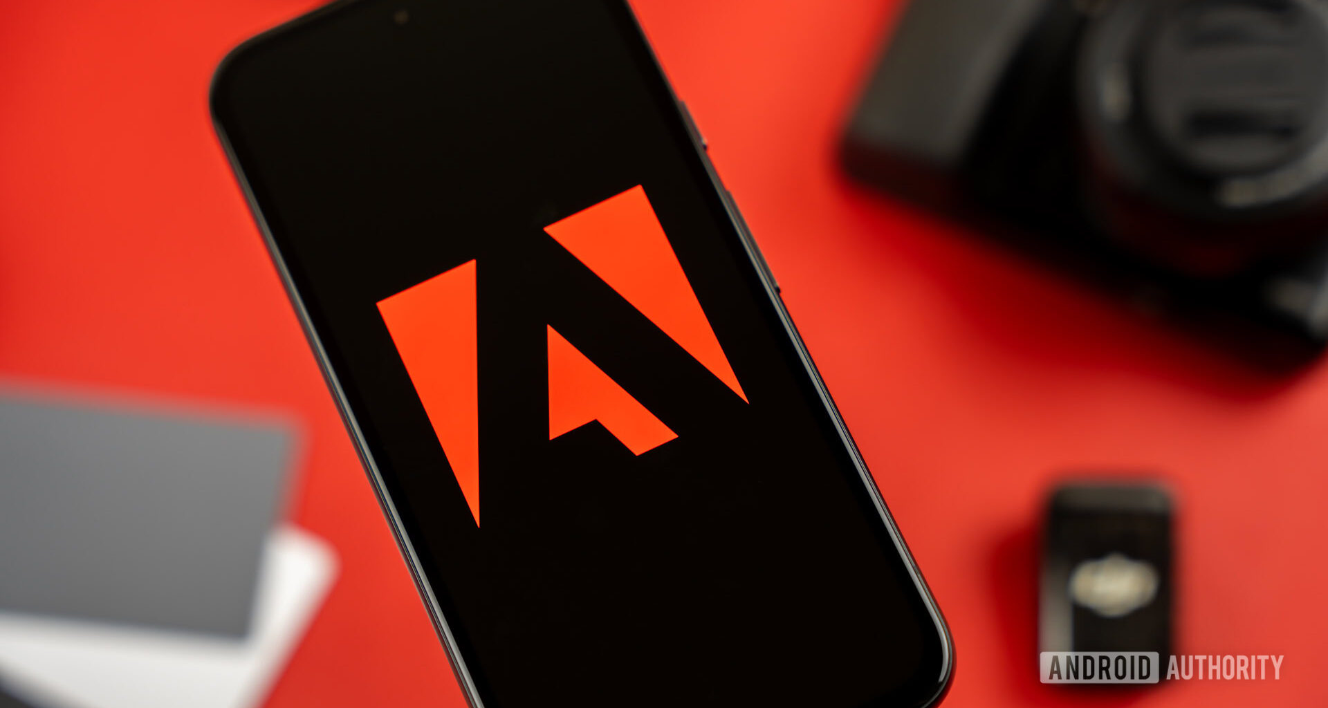 Adobe logo on smartphone, next to photography and videography products stock photo (6)