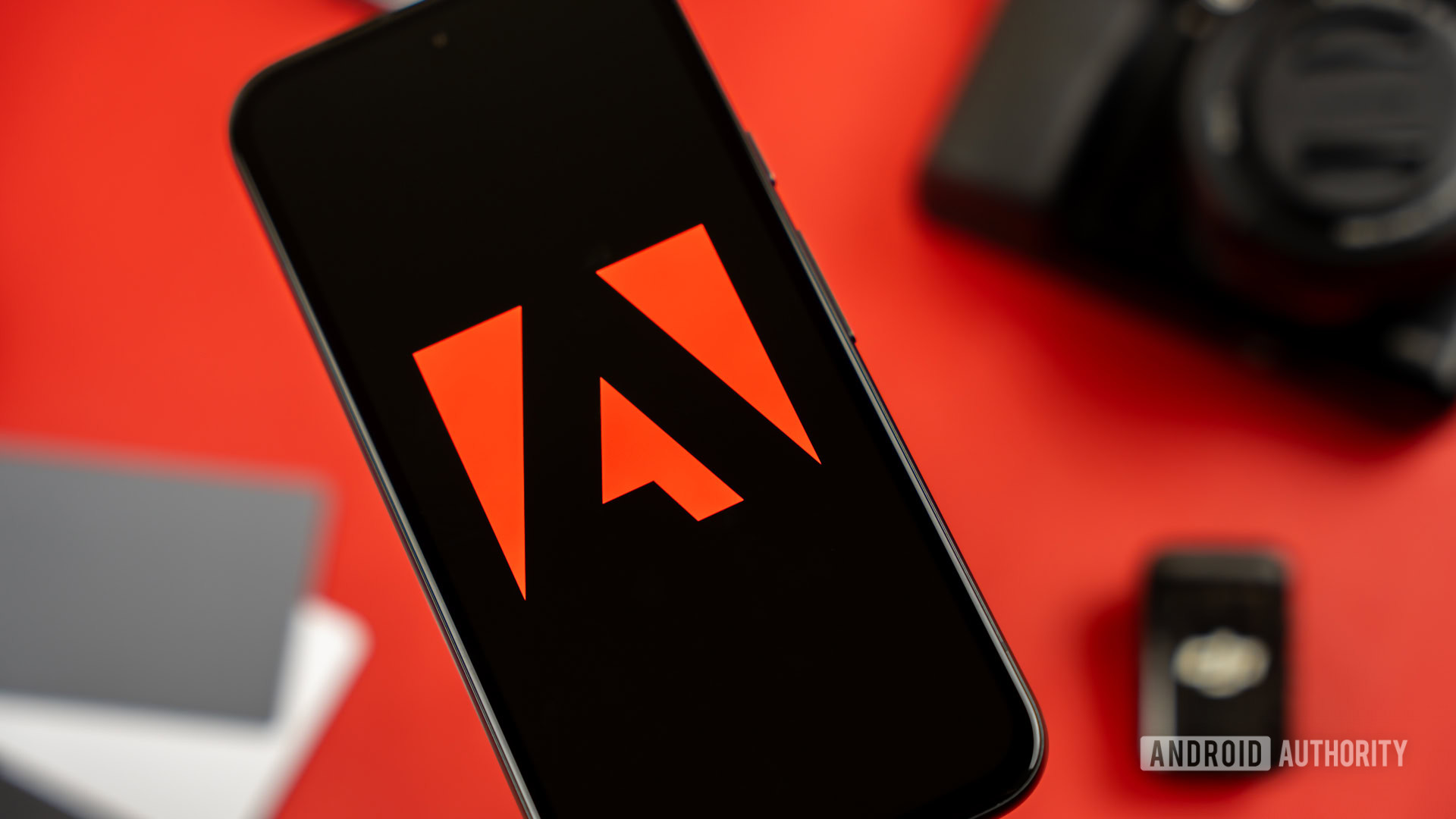 Adobe logo on smartphone, next to photography and videography products stock photo (6)