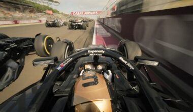 Onboard view from a black and gold Formula 1 car racing alongside several other cars on a track, with "Qatar Airways" banner visible above. The scene captures high speed and intense competition.