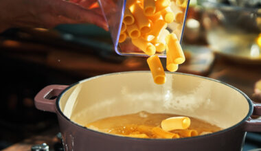 Glass jar of pasta being poured into casserole dish