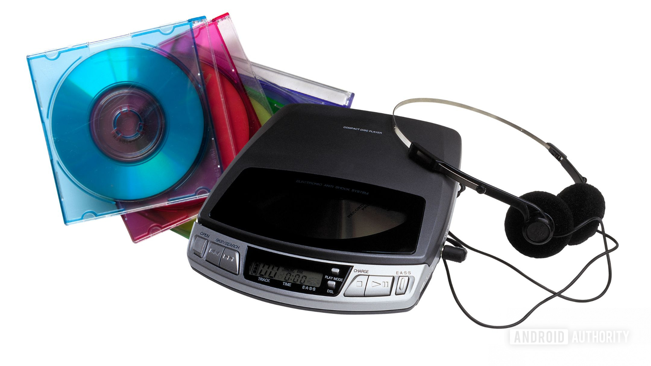 A portable CD player and a pile of CDs in colorful cases against a white background.
