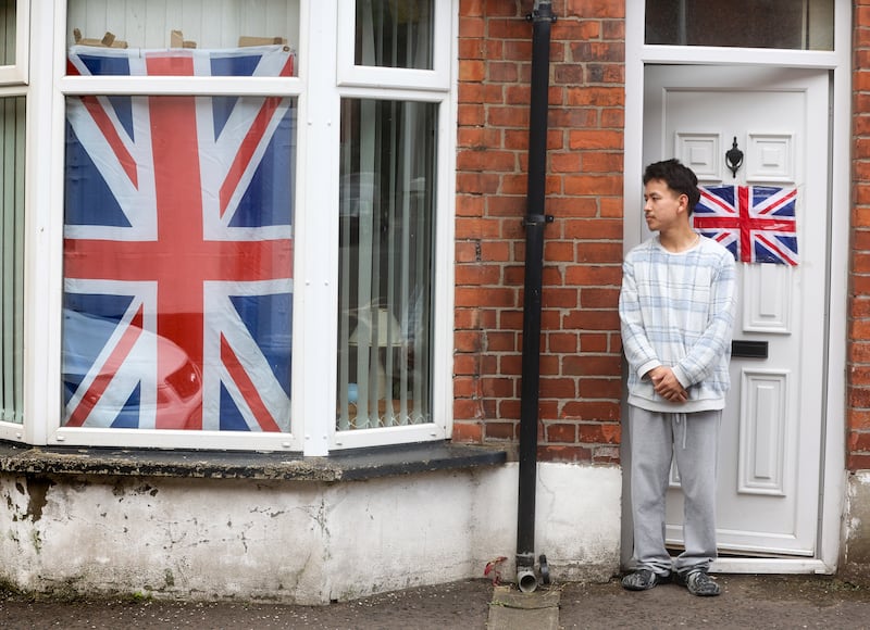 Flags and bunting and other british emblems in the windows of homes in Ballymena following anti-migrant intimidation earlier this month. PICTURE: MAL MCCANN