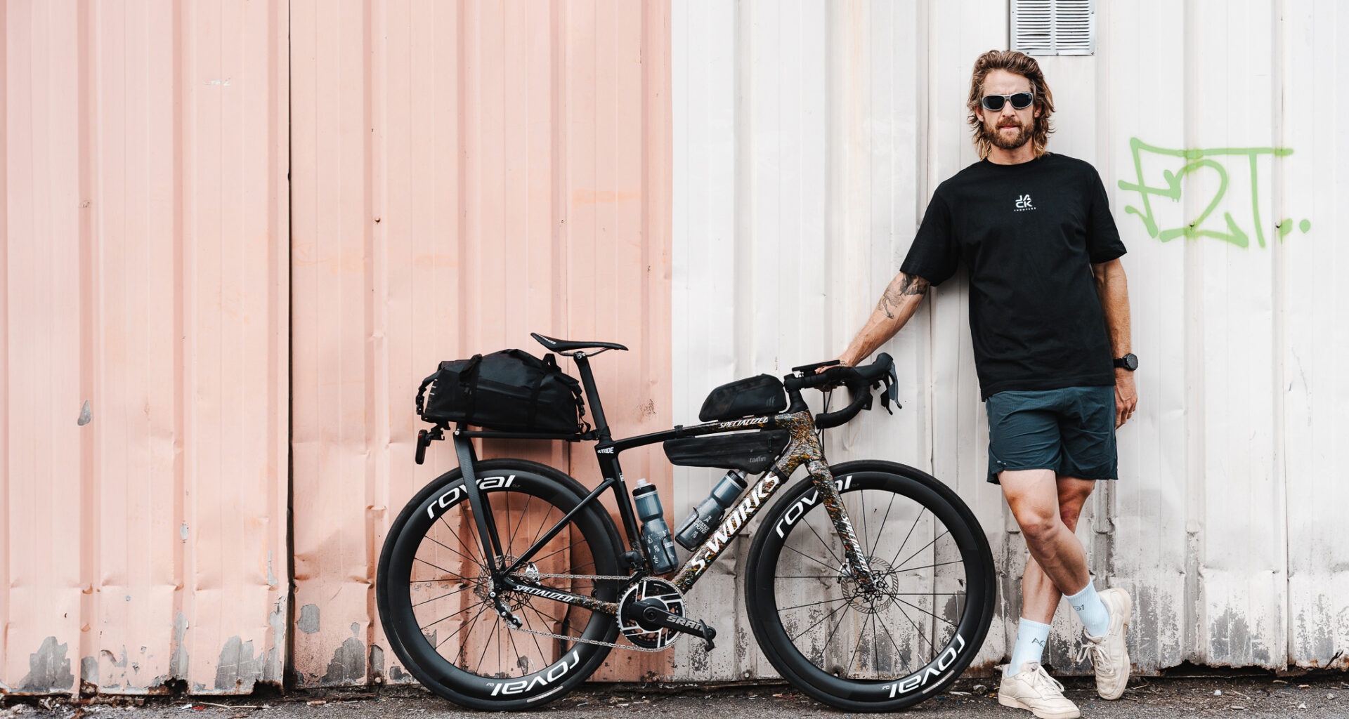 Jack Thompson, ultracyclist, standing next to his custom 2 speed Specialized Roubaix SL8 ahead of his project 1903 challenge.