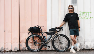 Jack Thompson, ultracyclist, standing next to his custom 2 speed Specialized Roubaix SL8 ahead of his project 1903 challenge.