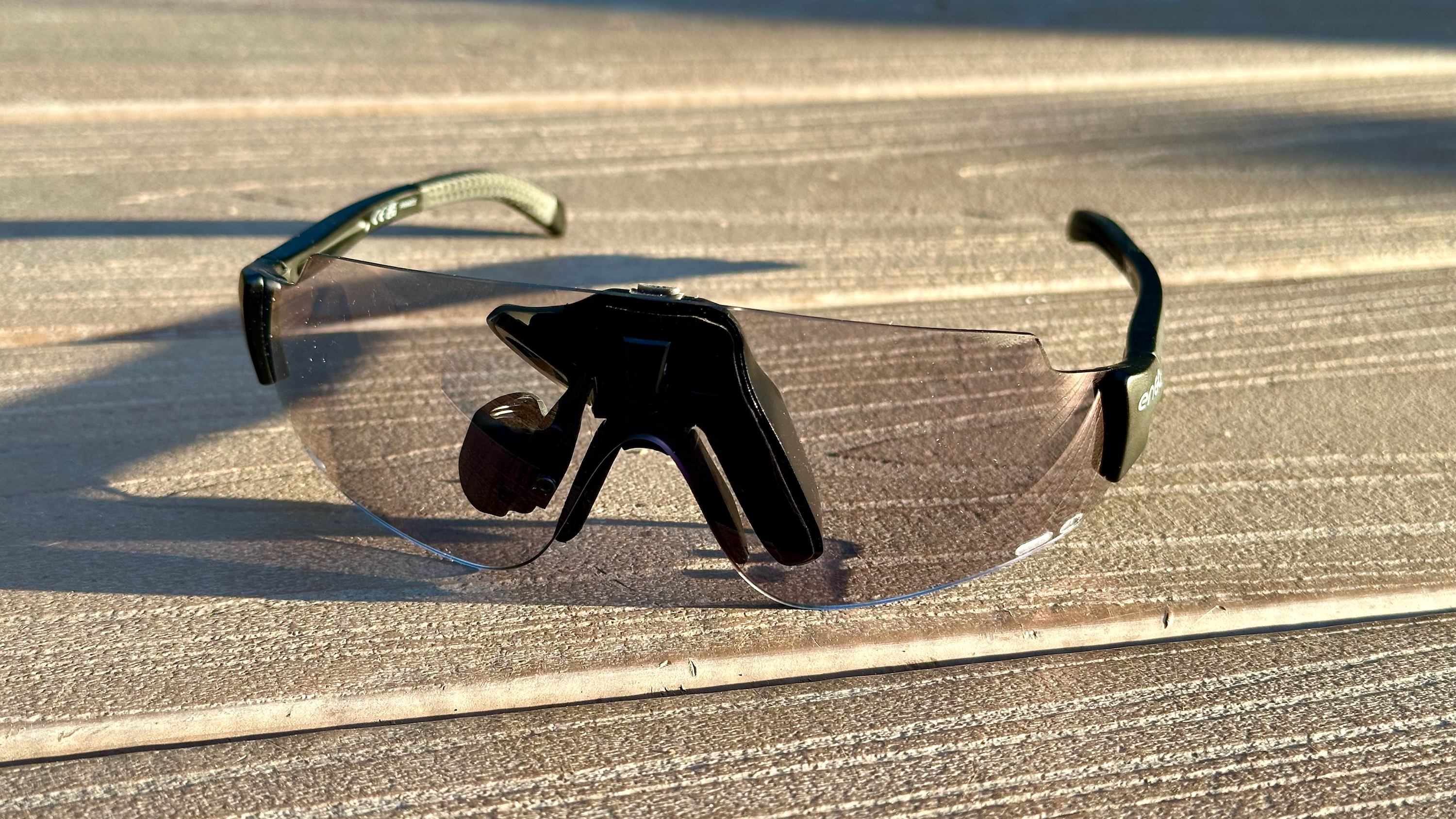 ENGO 2 AR glasses sitting on a deck at a front-left-facing angle.