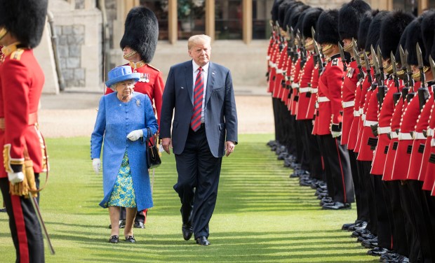 WINDSOR, ENGLAND - JULY 13: U.S. President Donald Trump and Britain's Queen Elizabeth II inspect a Guard of Honour, formed of the Coldstream Guards at Windsor Castle on July 13, 2018 in Windsor, England. Her Majesty welcomed the President and Mrs Trump at the dais in the Quadrangle of the Castle. A Guard of Honour, formed of the Coldstream Guards, gave a Royal Salute and the US National Anthem was played. The Queen and the President inspected the Guard of Honour before watching the military march past. The President and First Lady then joined Her Majesty for tea at the Castle. (Photo by Richard Pohle - WPA Pool/Getty Images)
