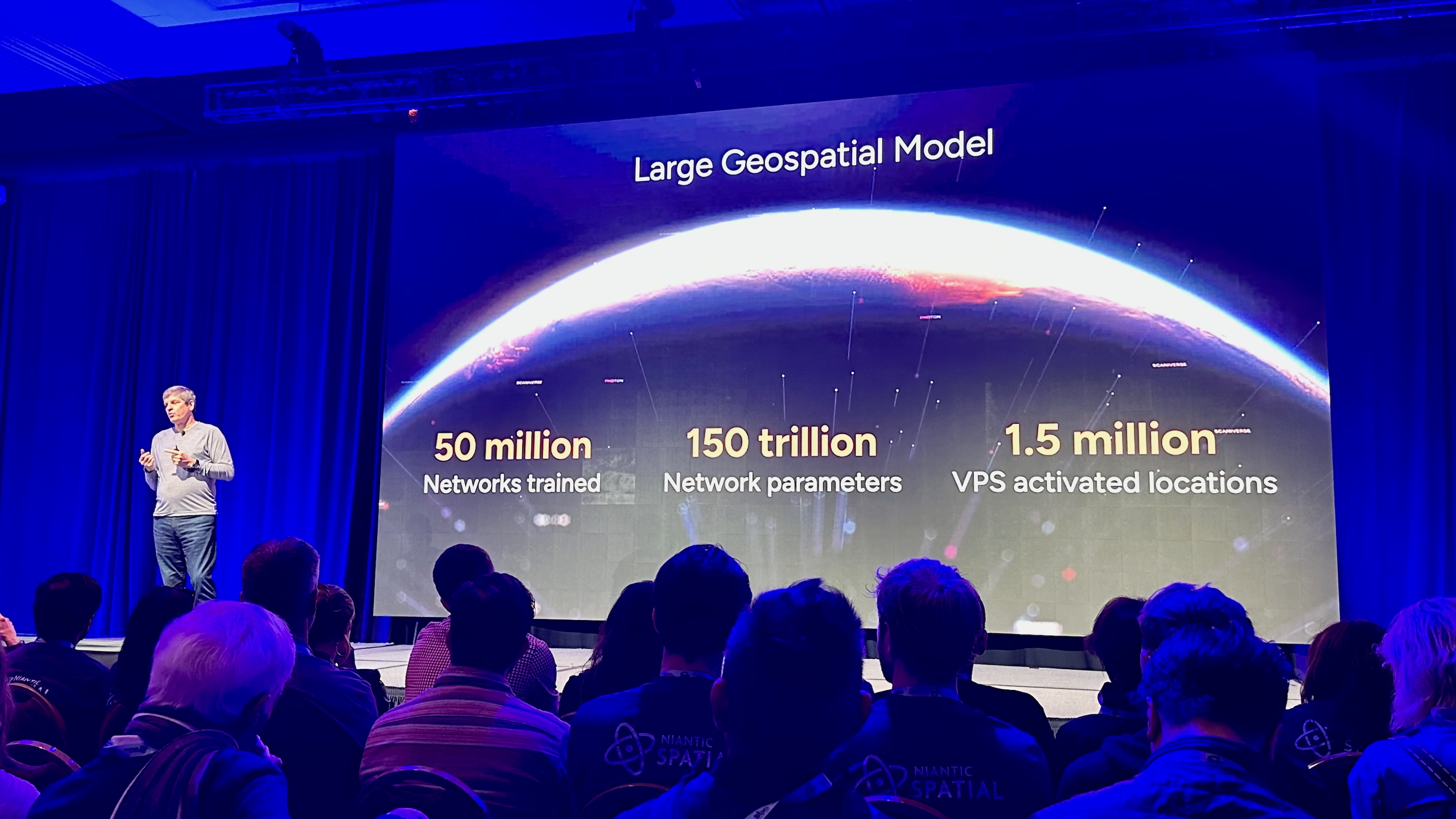 A Niantic Spatial rep describing their new geospatial model on stage at AWE 2025 for the panel 