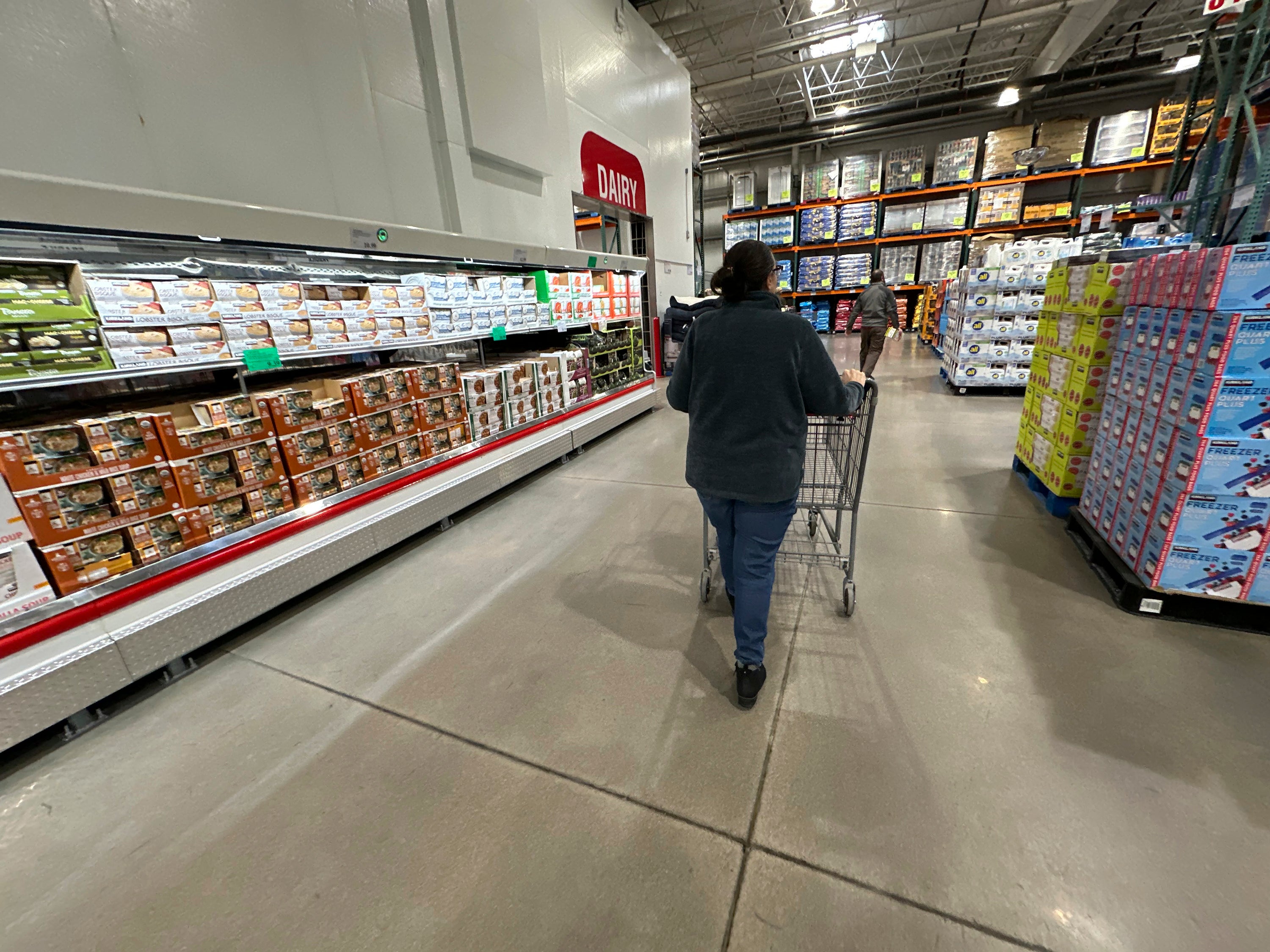 A shopper pushes a cart past a display of soups in a Costco warehouse in Sheridan, Colorado