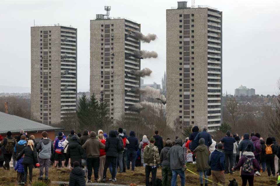 GLASGOW, SCOTLAND - MARCH 23: Wyndford flats are demolished during a controlled explosion on March 23, 2025 in Glasgow, Scotland. Four 26-storey residential tower blocks at Wyndford Road in North Glasgow are being brought down to make way for a redevelopment plan that will see nearly four hundred new homes and a community hub built in the area. Three of the four 1960's era towers are being demolished with explosives, while a fourth is being dismantled manually. (Photo by Jeff J Mitchell/Getty Images)