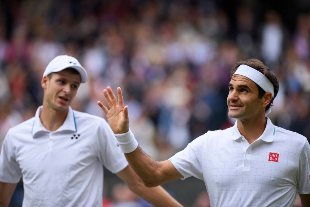 Roger Federer waves to the crowd after losing at Wimbledon in 2021.
