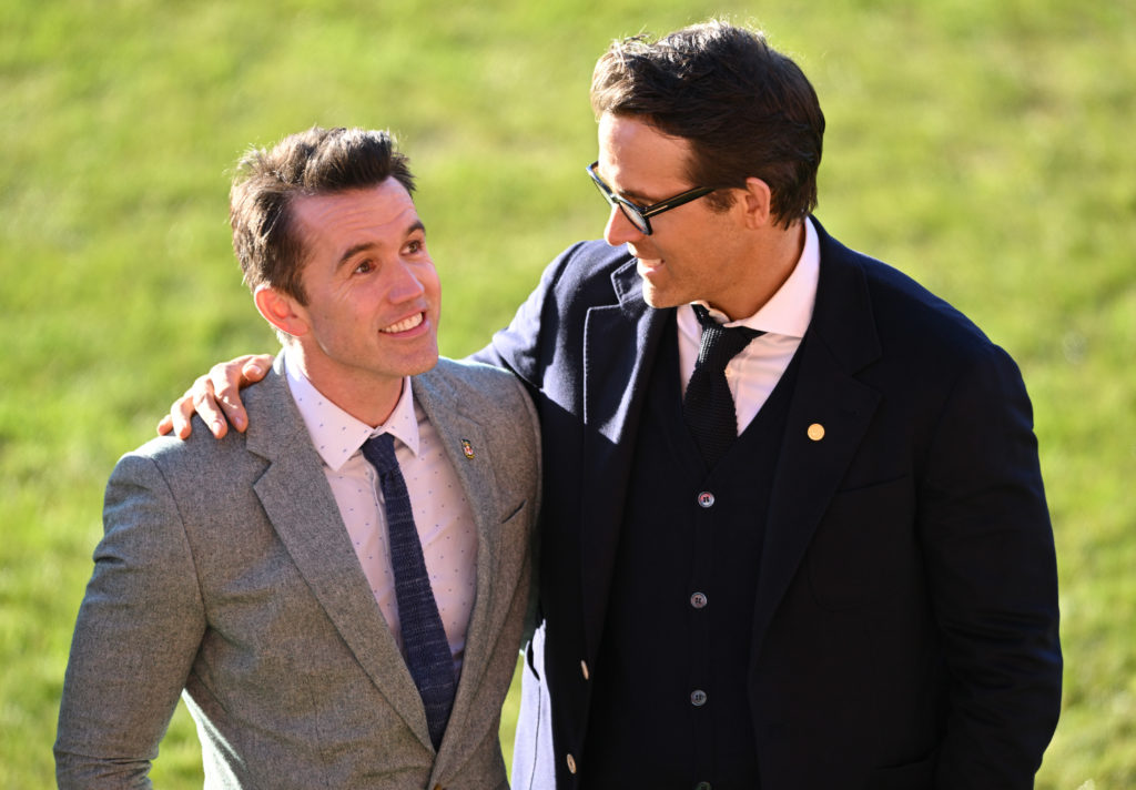 Co-Owners of Wrexham AFC Rob McElhenney and Ryan Reynolds talk as they wait for the arrival of King Charles III and Camilla, Queen Consort during their visit to Wrexham AFC.
