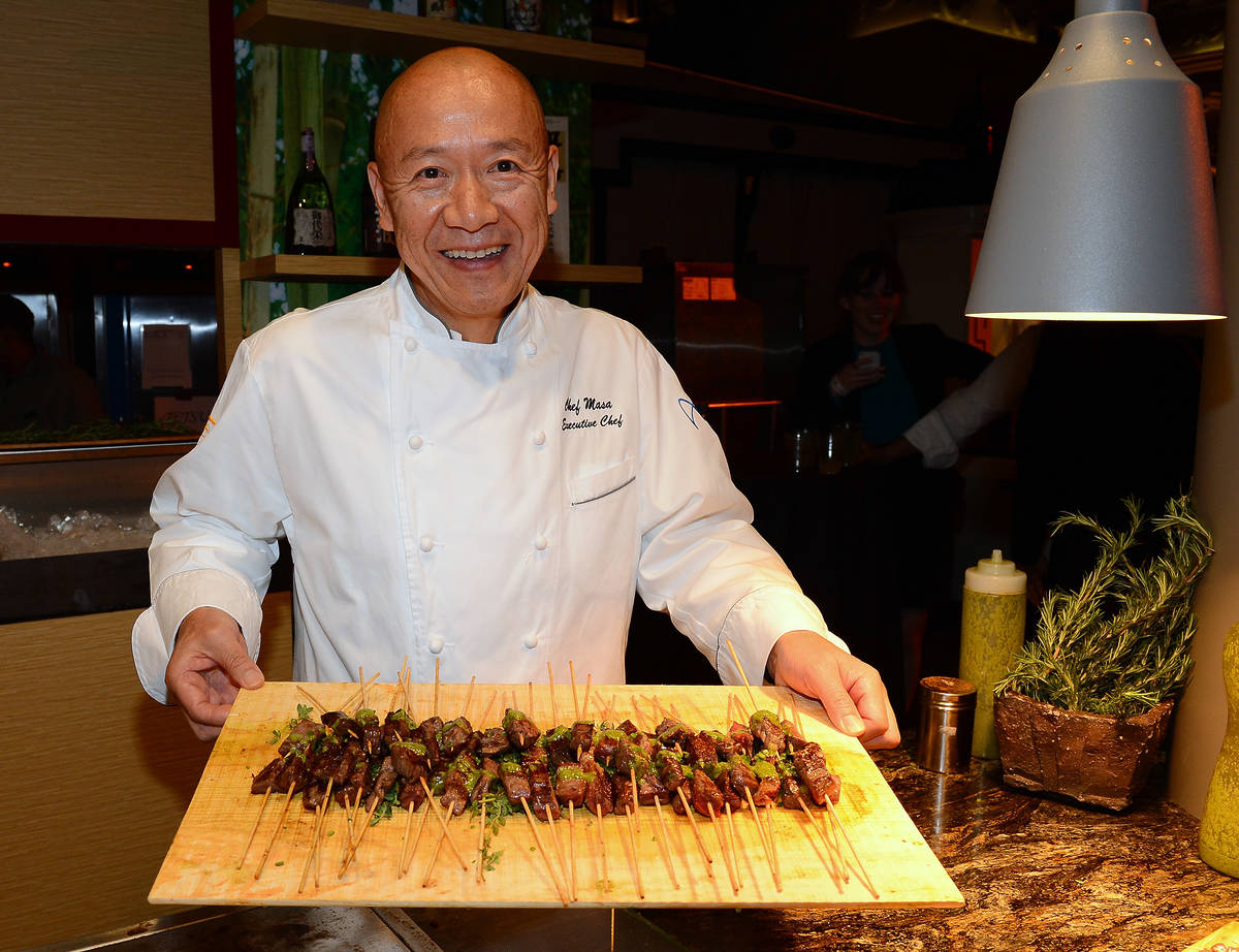 Chef Masayoshi Takayama serves Australian double black label beef skewers at the Tetsu booth at Vegas Uncork'd by Bon Appetit's Grand Tasting event at Caesars Palace on May 10, 2013 in Las Vegas, Nevada. (Photo by Ethan Miller/Getty Images for Vegas Uncork'd by Bon Appetit)