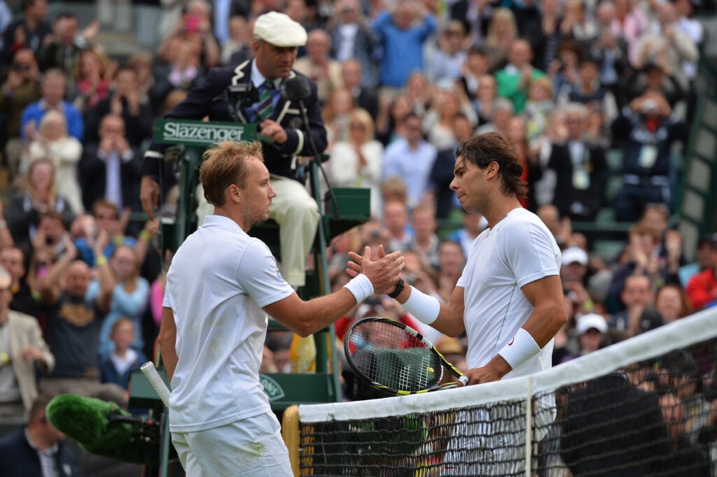 Steve Darcis and Rafael Nadal shaking hands at the net after their first round match at Wimbledon in 2013.