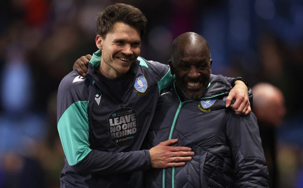 Danny Rohl and Chris Powell embrace each other after Sheffield Wednesday's win against QPR