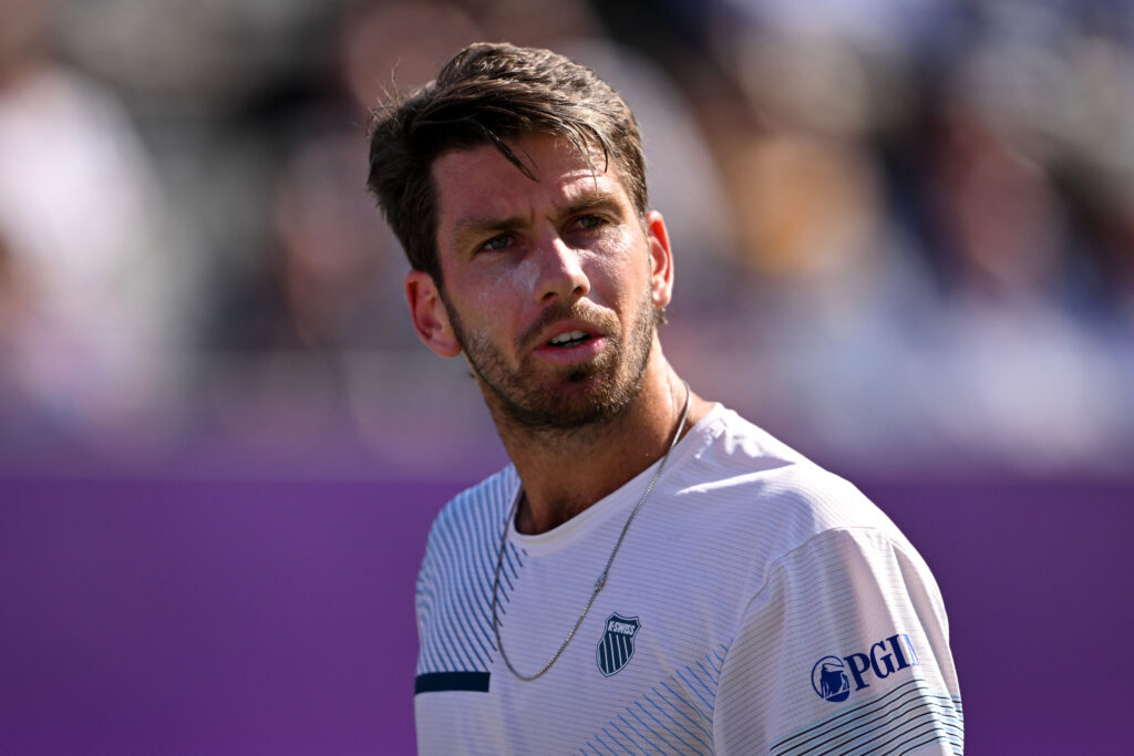 Cameron Norrie of Great Britain looks on against Milos Raonic of Canada during the Men's Singles Round of 32 match on Day One of the cinch Championships at The Queen's Club.