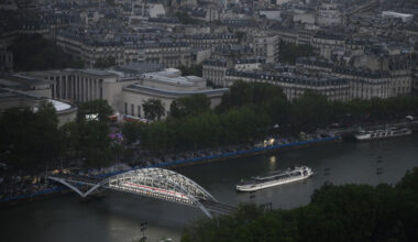PARIS, FRANCE - JULY 26:  A boat with members of Brazil's delegation sails past the Passerelle Debilly bridge on the River Seine with the Musée d'Art Moderne de Paris in the background during the Opening Ceremony of the Olympic Games Paris 2024 on July 26, 2024 in Paris, France. (Photo by Luis ROBAYO - Pool/Getty Images)
