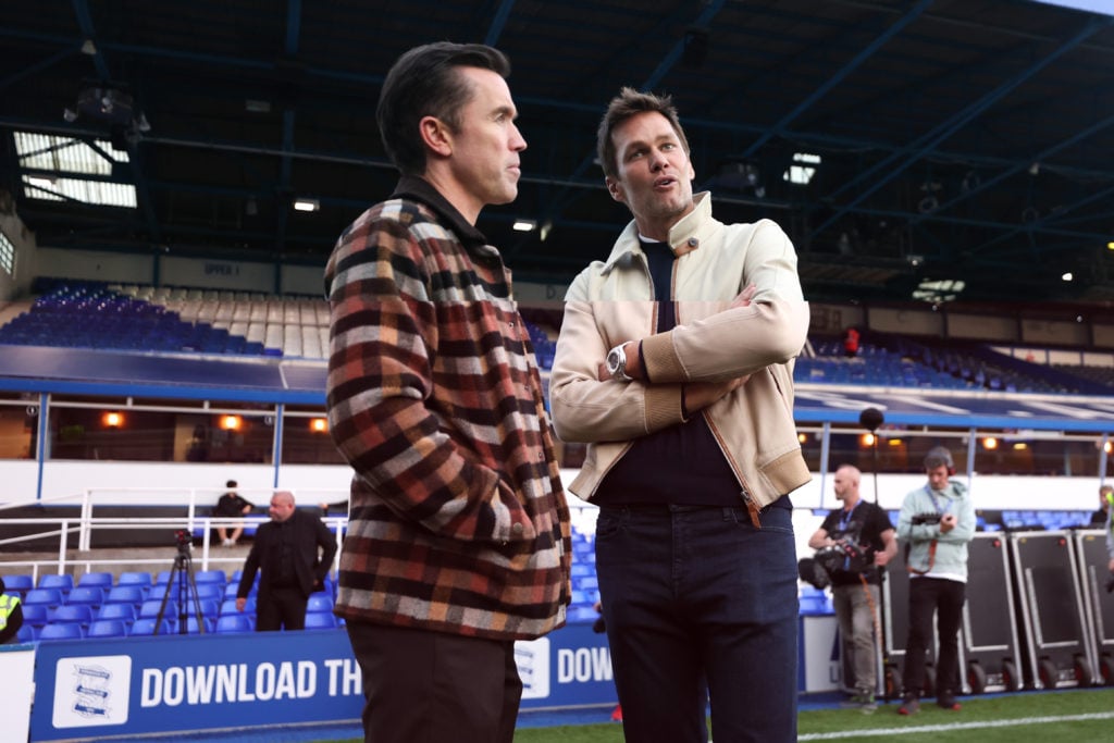 Birmingham City minority owner Tom Brady talks with Wrexham co-owner Rob McElhenney.