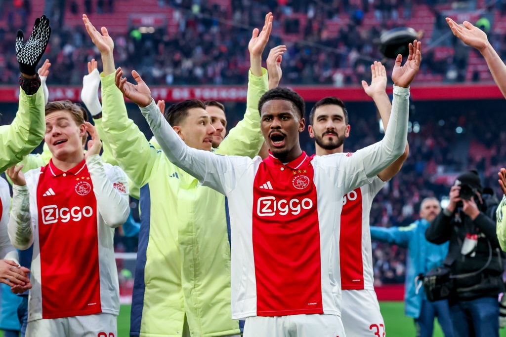 Jorrel Hato of Ajax celebrates with fans after winning an Eredivise match against Feyenoord
