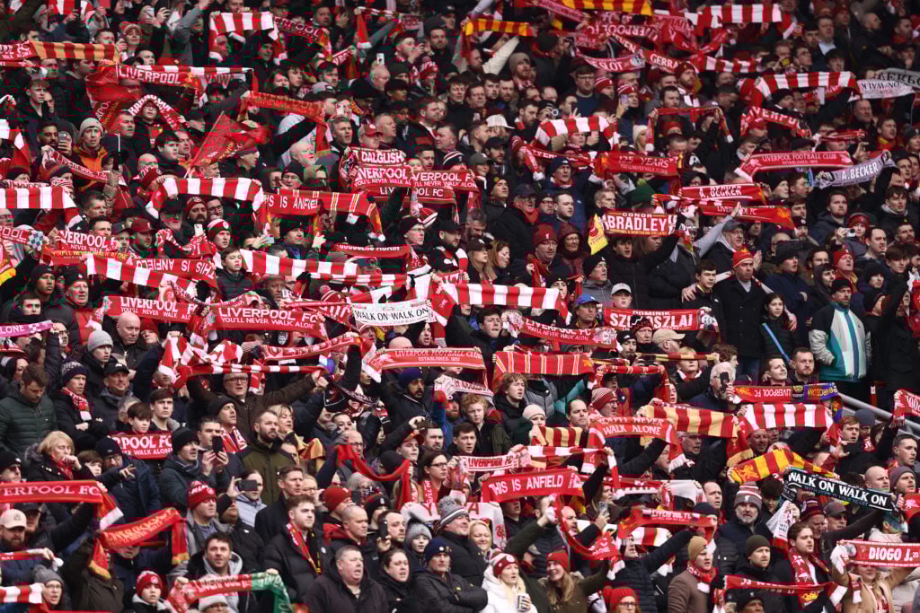 Liverpool fans raise scarves aloft at Anfield
