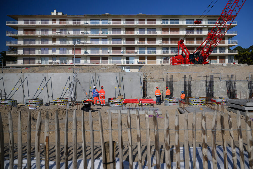 A crew works to construc a sea wall to reduce the risk of coastal flooding and erosion due to sea level rise on March 4 in La Baule, France. Credit: Loic Venance/AFP via Getty Images