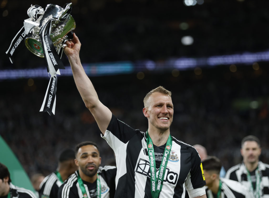 Dan Burn lifts the Carabao Cup after Newcastle United's win against Liverpool at Wembley Stadium.