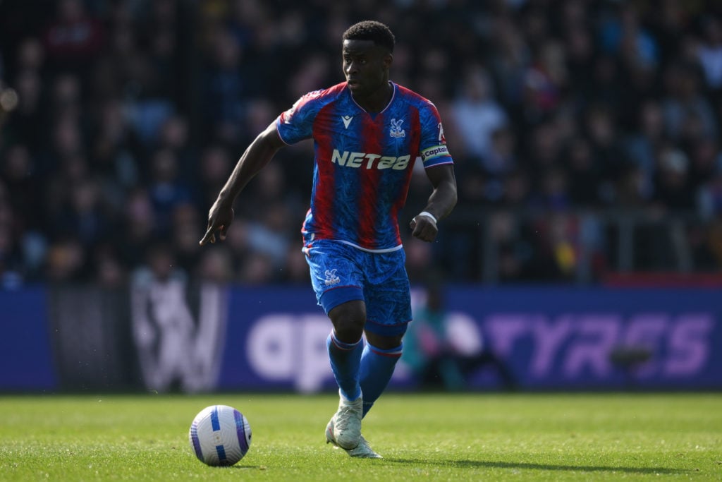 Crystal Palace defender Marc Guehi runs with the ball during a Premier League match against Bournemouth at Selhurst Park.