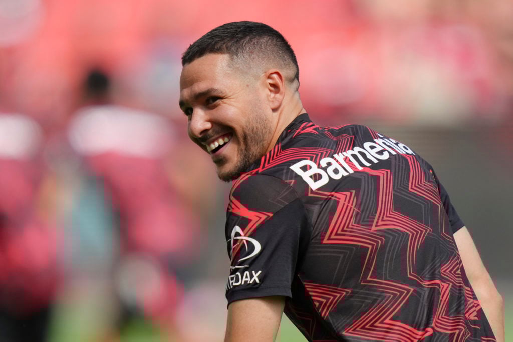 Emi Buendia smiles while warming up for Bayer Leverkusen.