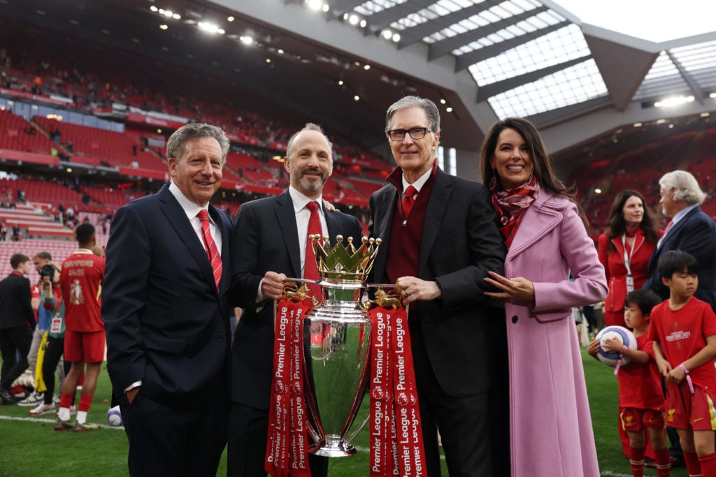 Liverpool owners John Henry, Mike Gordon and Tom Werner hold the Premier League trophy